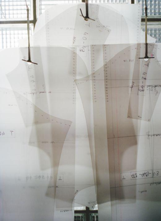 Paper pattern pieces hanging in a studio